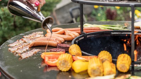 Impressionen aus unserem Natur- und Alpinhotel in Vent Grillen von Gemüse und Würstchen auf einer runden Grillstelle im Freien