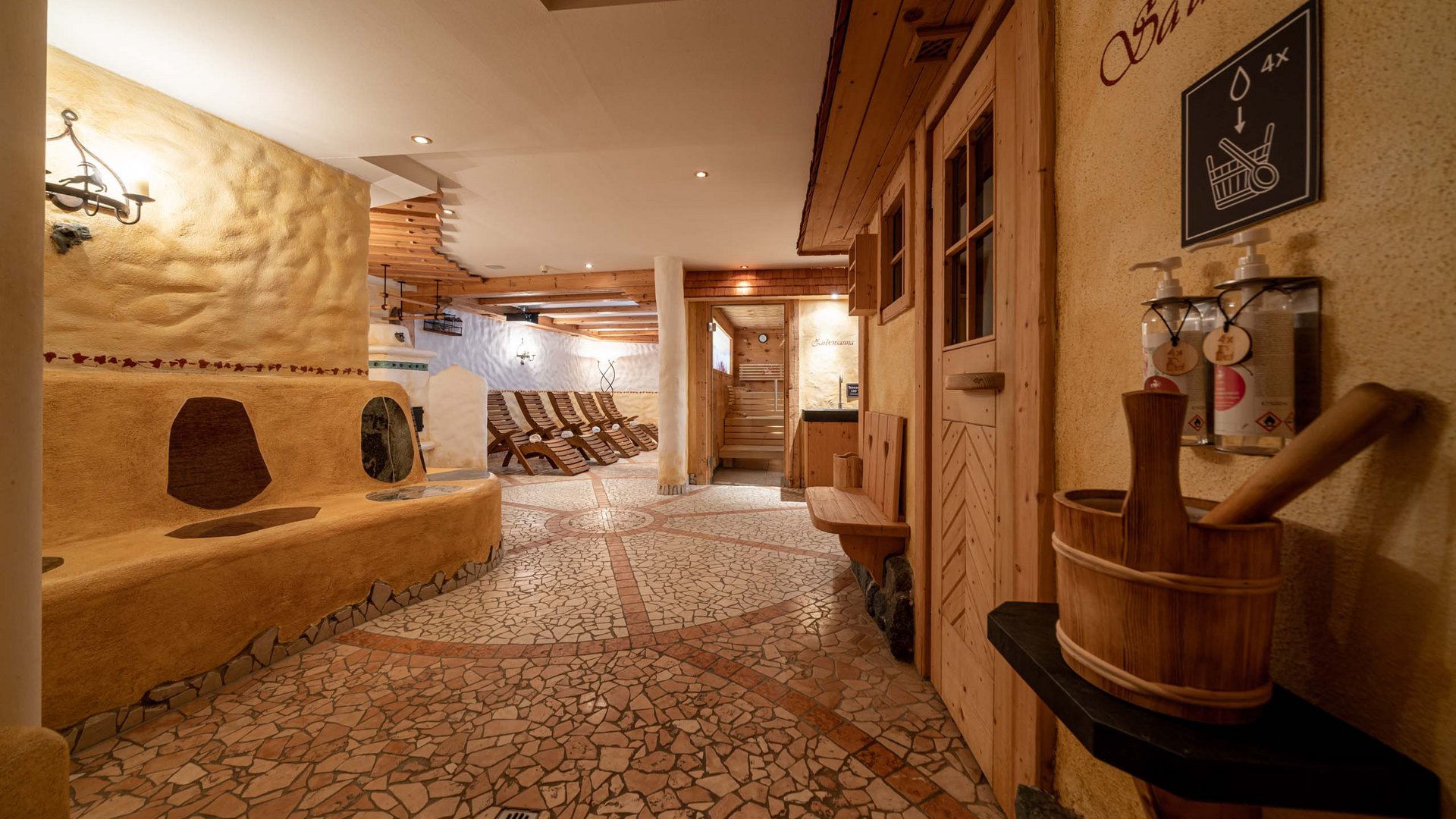 Sauna village & mountain lake: our hotel in Tyrol with pool Interior of a wellness area with sauna room and lounge chairs